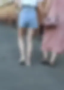 Pale Slim Legs of a Girl in Denim Shorts Street Photo