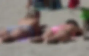 Sexy brunette on the beach in a bikini with great tits