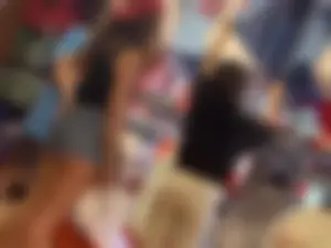 Bunch of girls in various outfits at a Cardinals baseball game