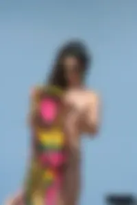 2 topless girls at the beach in thongs