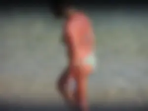 Blonde milf on the beach in her bikini