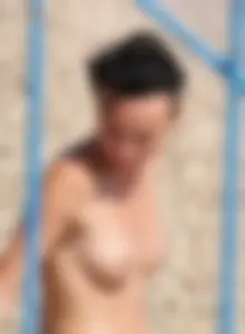 Cute brunette lady topless at the beach with awesome tits