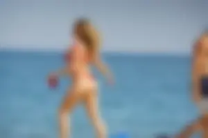 Hot blonde with a slammin body in red thong bikini on the beach