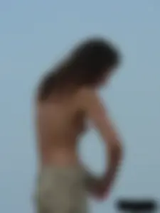 Sexy babe with a nice body topless and in a thong on the beach
