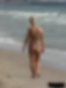 Tattooed blonde with big tits topless and in thong