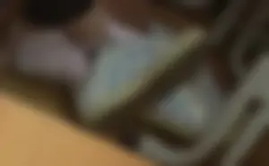 Teen college student's feet in ping socks and sneakers under desk closeup candid photos and a video