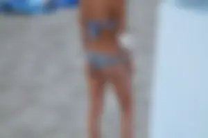 Sexy girl playing beach volleyball in a bikini