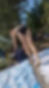 A pretty brown haired woman bending over with her nice ass in a black bikini on the beach. oc
