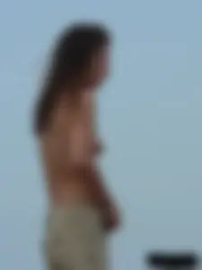 Sexy babe with a nice body topless and in a thong on the beach