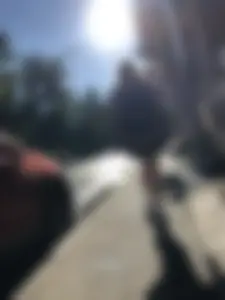 Skinny Girl in a Skirt Walking Down the Street and Hugging Her Friend Candid