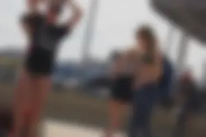 A group of teens in bikinis on the beach