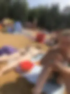 Topless Skinny Girl With Very Pale Skin Lying on a Beach on Her Tummy With Slightly Spread Legs Creepshots Gallery