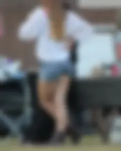 Hippie type dressed girl in denim shorts with a nice ass