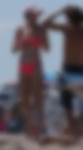 Sexy and skinny girl on the beach in pink bikini