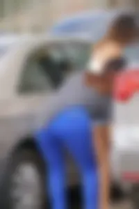 Sexy dog walker in shorts and tank top with friend in blue jeans