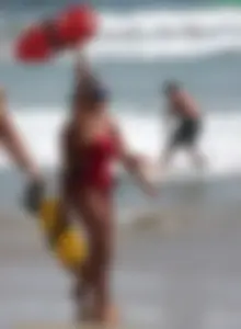 Two sexy lifeguards in red and blue swimsuits