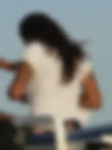 Topless tattooed lady on the beach with fake big tits