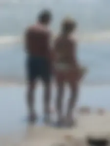Sexy blonde on the beach in a yellow thong bikini