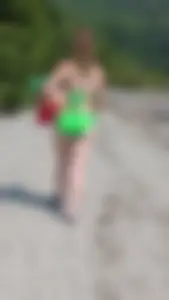Beautiful Brown hair tight Girl in green bikini on the beach. oc