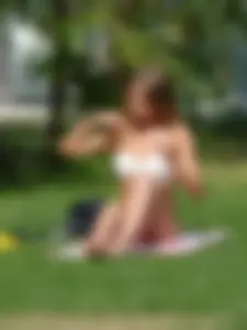 Hot Girl in Swimsuit Sunbathing on the Park Lawn Candid Photo Gallery
