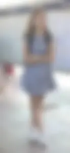 Cute girl wearing a dress at the train station