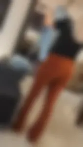 Blonde dutch shop assistent in orange cord leggings