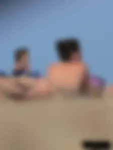 Sexy babe with a nice body topless and in a thong on the beach