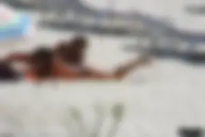 Topless milf and her topless daughter on the beach