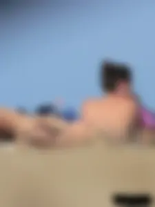 Sexy babe with a nice body topless and in a thong on the beach