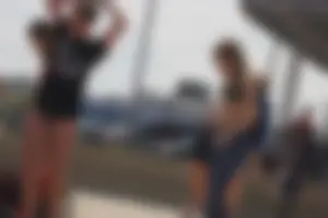 A group of teens in bikinis on the beach