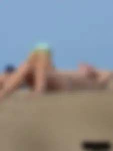 Sexy babe with a nice body topless and in a thong on the beach