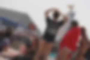 A group of teens in bikinis on the beach