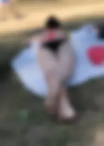 Pale Skinny Girl Lying on the Beach in Swimsuit With Crossed Legs Candid Gallery