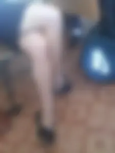 Teen in a Skirt and Flats Sitting Crosslegged Classroom Candid