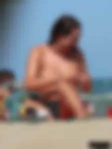 Bunch of sexy babes on the beach topless and in thong bikinis