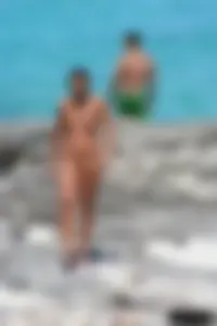 Older lady on a nude beach showing her body