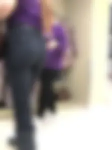 Cute candid shop assistant wearing boots and tight pants