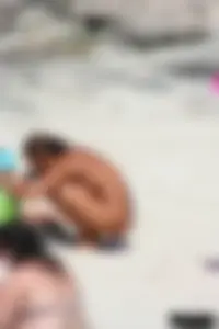 Older lady on a nude beach showing her body