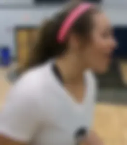 Bunch of cute college girls in bright pink shorts playing volleyball