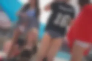 A group of teens in bikinis on the beach