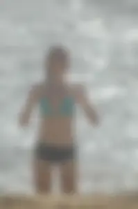 Blonde lady on the beach in bikini top and spandex shorts with a nice gap