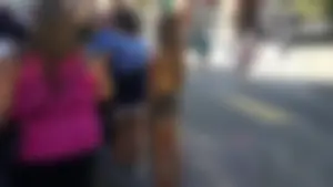 Girl in shorts and sandals on the street busted