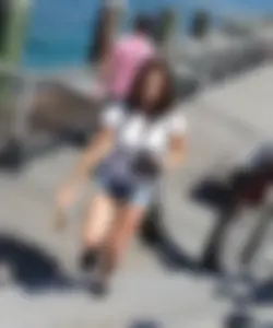 Pretty girl with a camera in little denim shorts