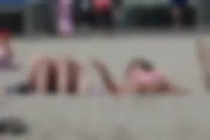 Sexy brunette on the beach in a bikini with great tits