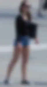 Cute girl with nice legs in short denim shorts