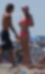 Sexy and skinny girl on the beach in pink bikini