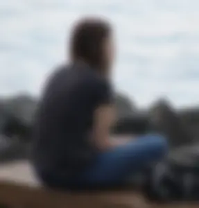 Cute brunette in jeans by the water