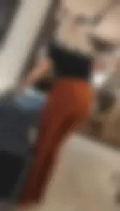 Blonde dutch shop assistent in orange cord leggings