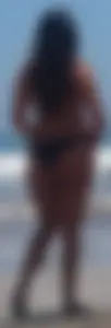 Thick brunette beach babe booty in a little black bikini