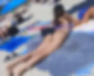 Milfs and girls resting at the beach in sexy bikinis